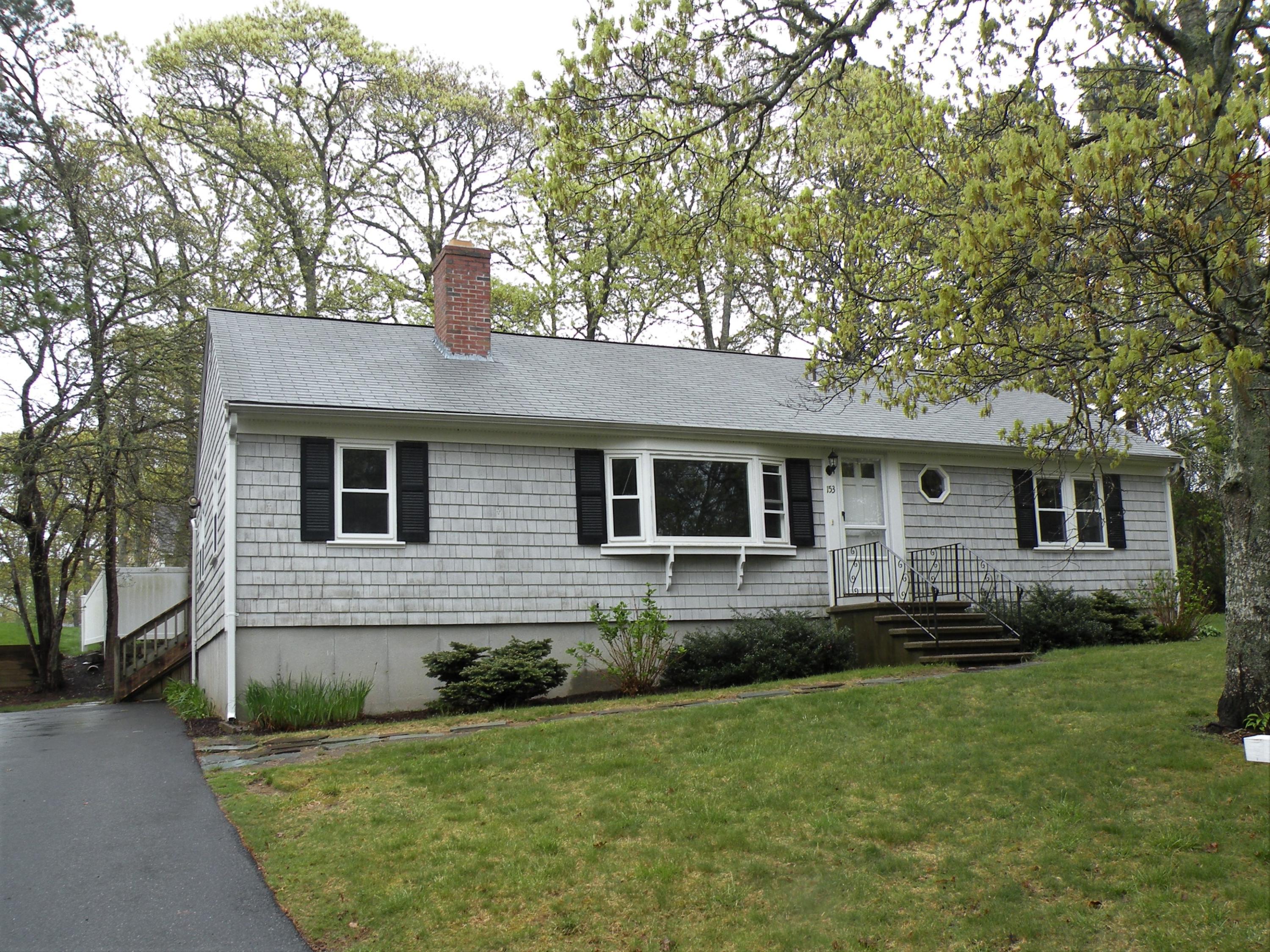 153 Harbor Hills Road Centerville, MA 02632 - Photo 1 of 18 a front view of a house with a garden