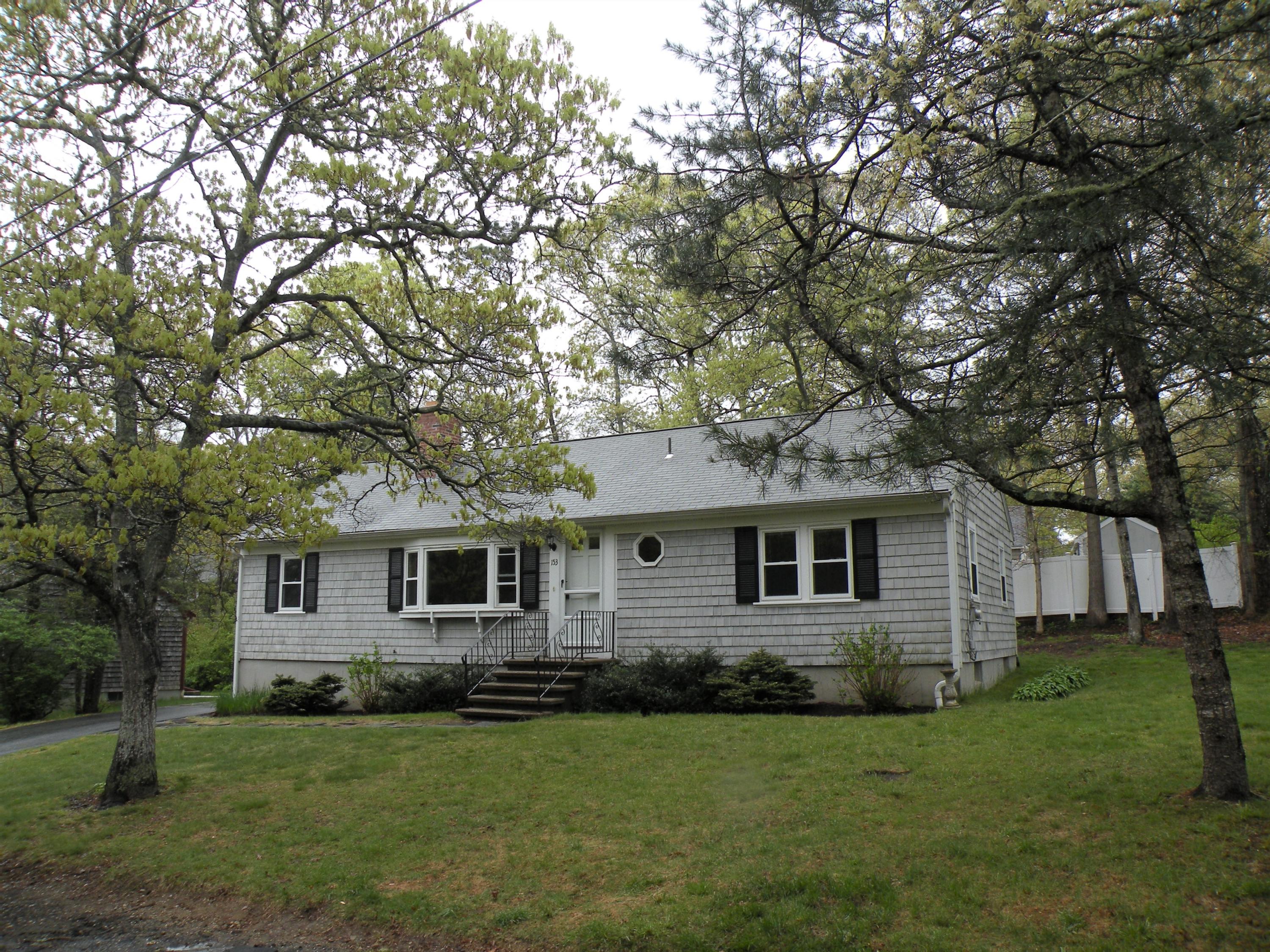 153 Harbor Hills Road Centerville, MA 02632 - Photo 2 of 18 a front view of a house with a garden