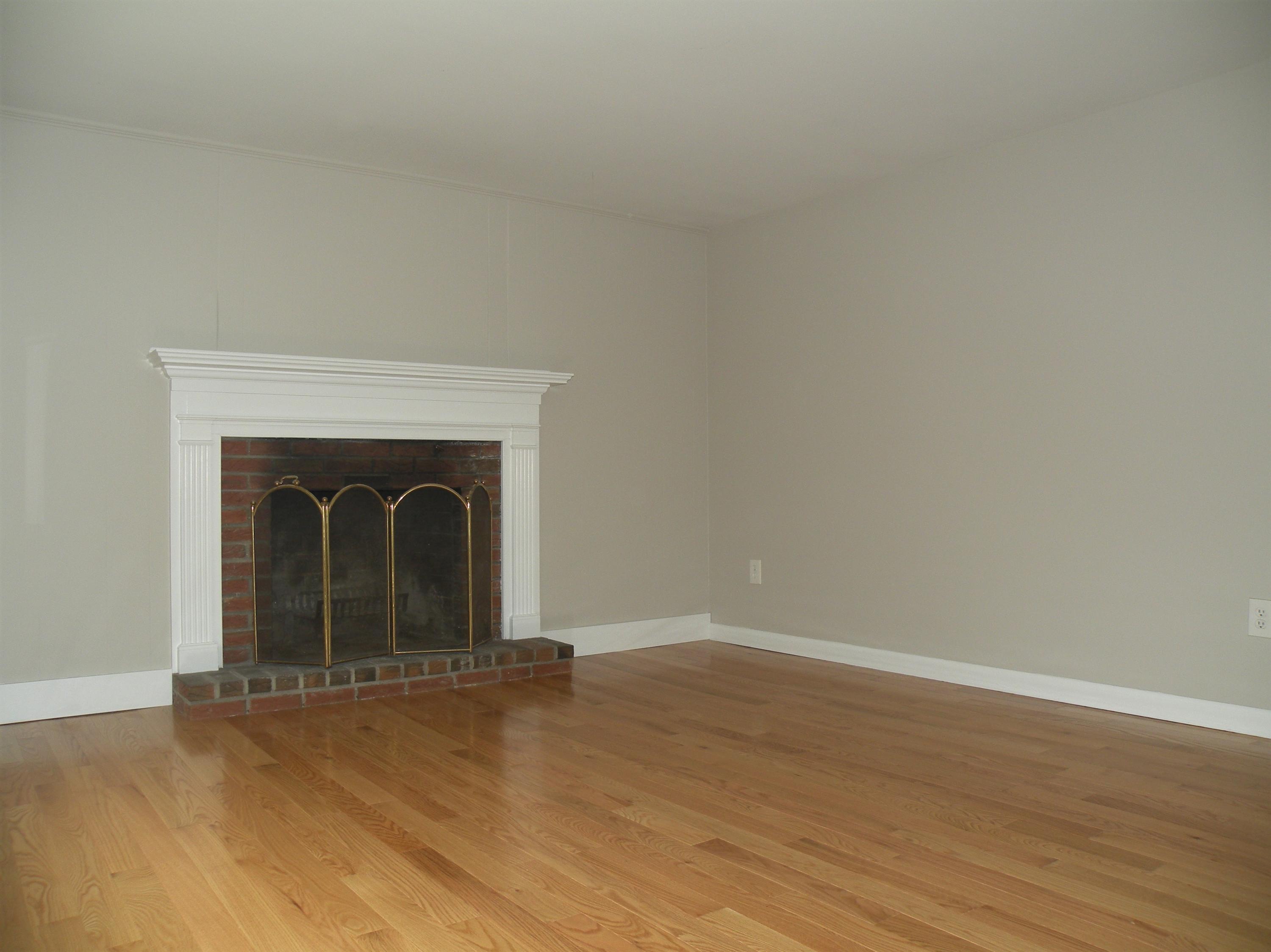 153 Harbor Hills Road Centerville, MA 02632 - Photo 3 of 18 a view of empty room with wooden floor and a fireplace