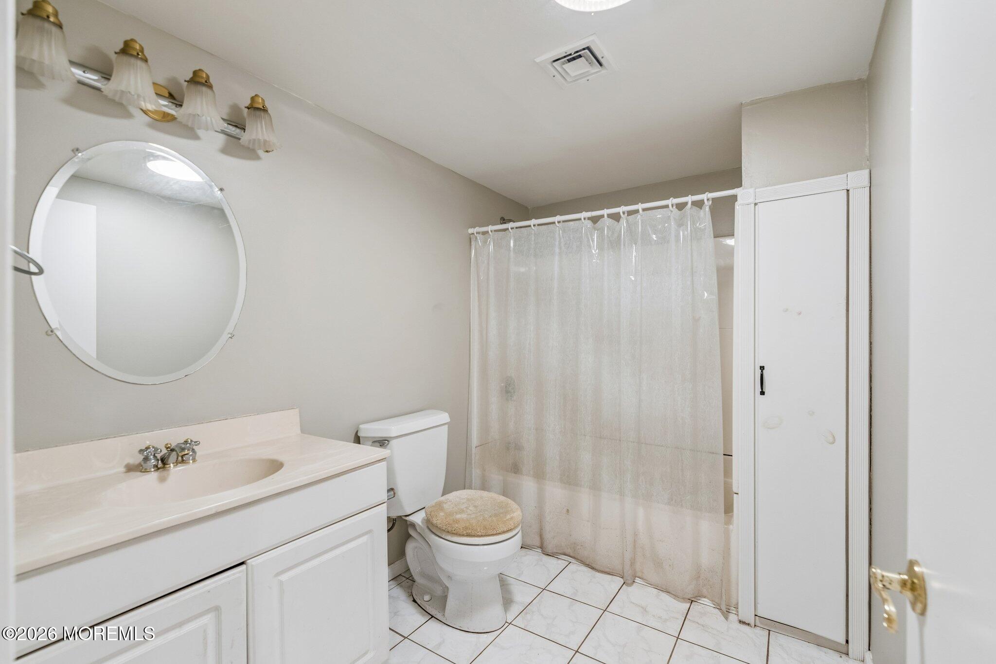 624 North Manetta Drive Point Pleasant, NJ 08742 - Photo 11 of 27 a bathroom with a sink mirror vanity and toilet