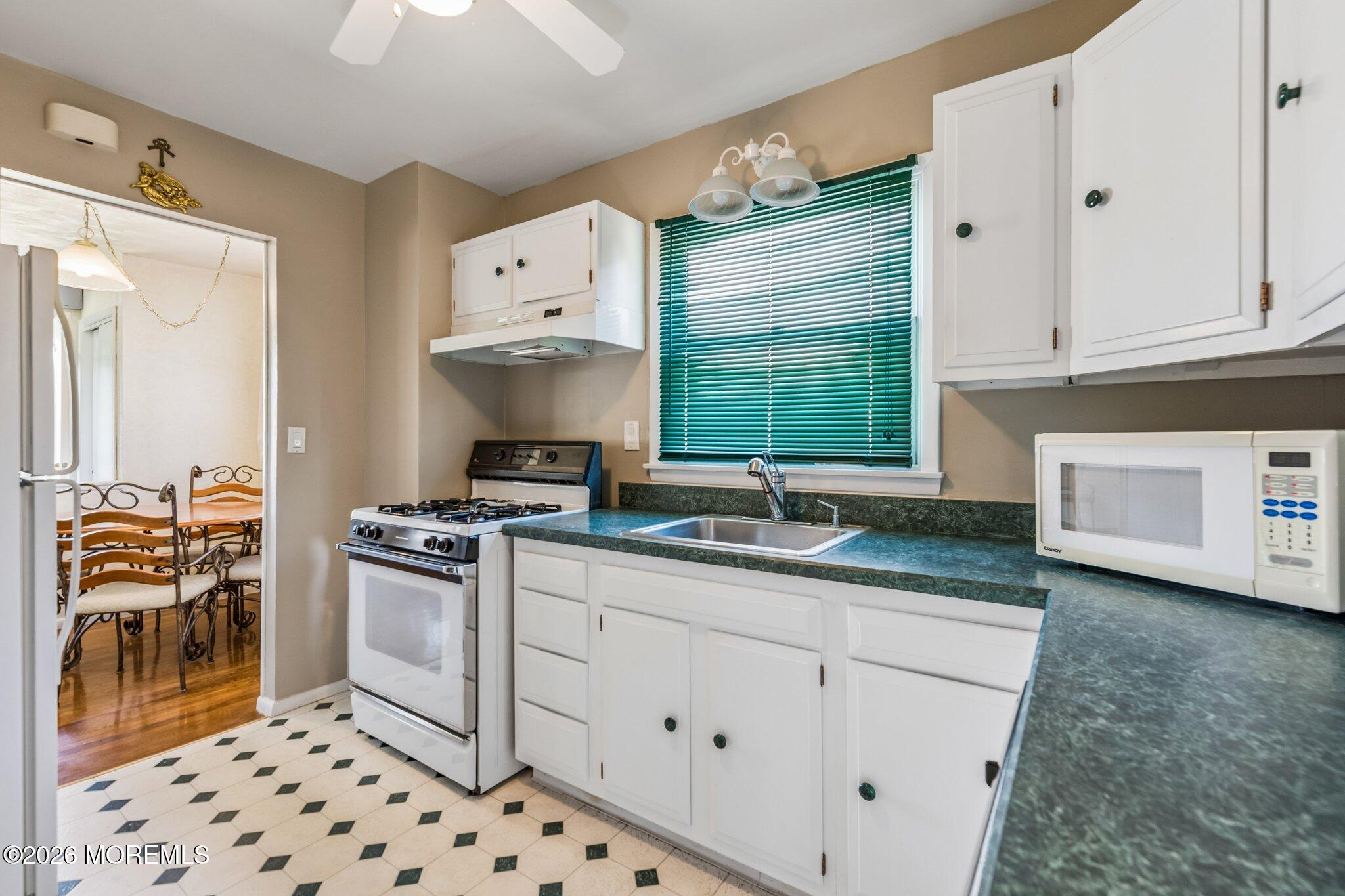 624 North Manetta Drive Point Pleasant, NJ 08742 - Photo 13 of 27 a kitchen with granite countertop a sink a stove and cabinets