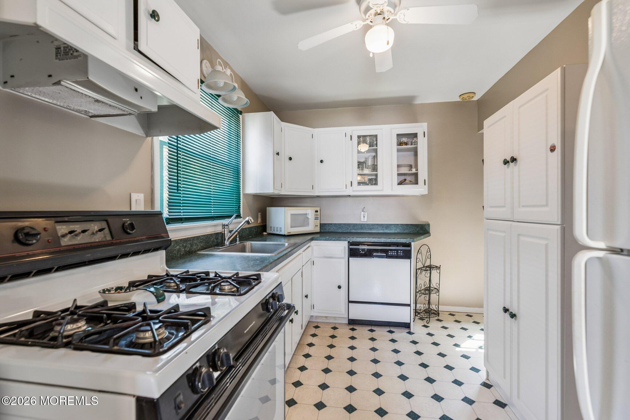 624 North Manetta Drive Point Pleasant, NJ 08742 - Photo 14 of 27 a kitchen with a stove a sink and a refrigerator