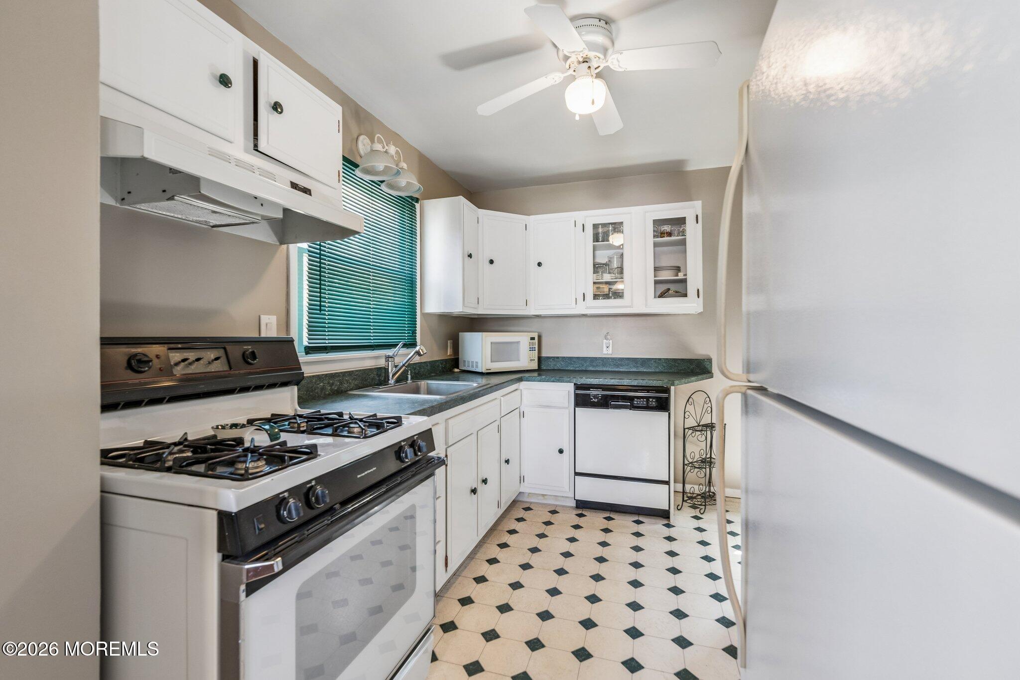 624 North Manetta Drive Point Pleasant, NJ 08742 - Photo 15 of 27 a kitchen with granite countertop a stove and a sink