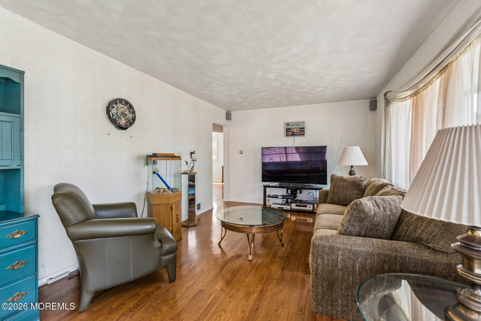 624 North Manetta Drive Point Pleasant, NJ 08742 - Photo 19 of 27 a living room with furniture and a flat screen tv
