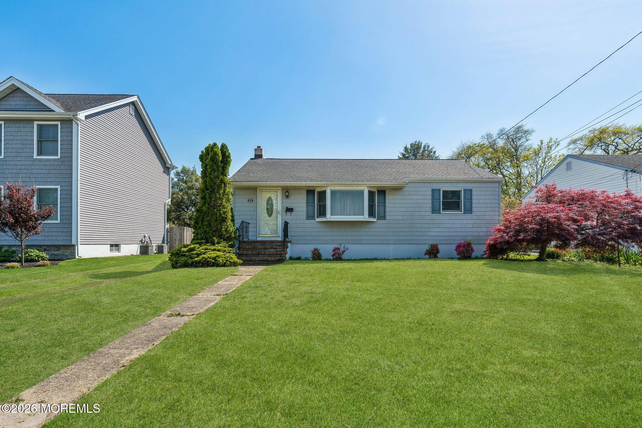 624 North Manetta Drive Point Pleasant, NJ 08742 - Photo 2 of 27 a front view of a house with a garden
