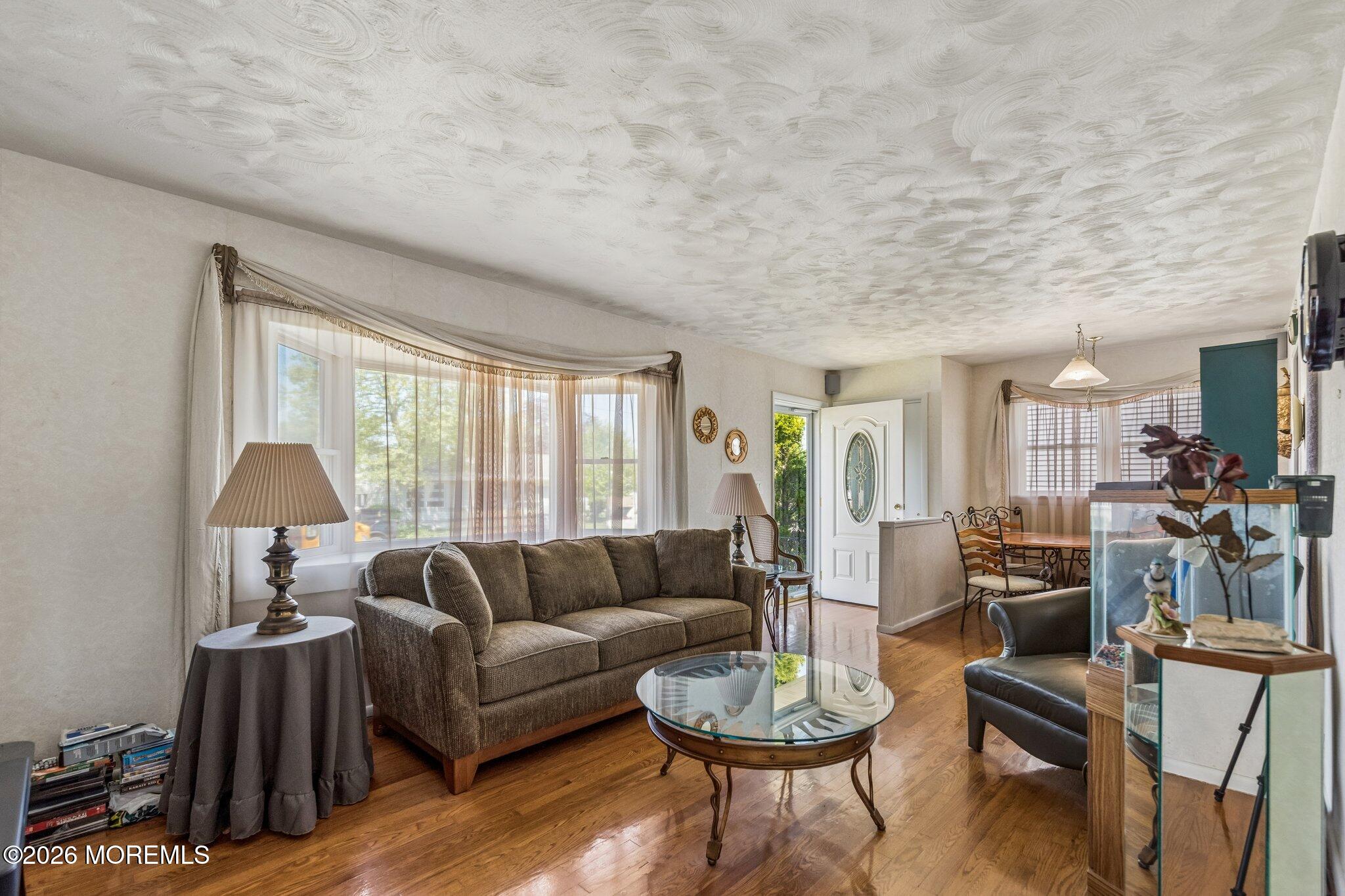 624 North Manetta Drive Point Pleasant, NJ 08742 - Photo 21 of 27 a living room with furniture a lamp and a large window