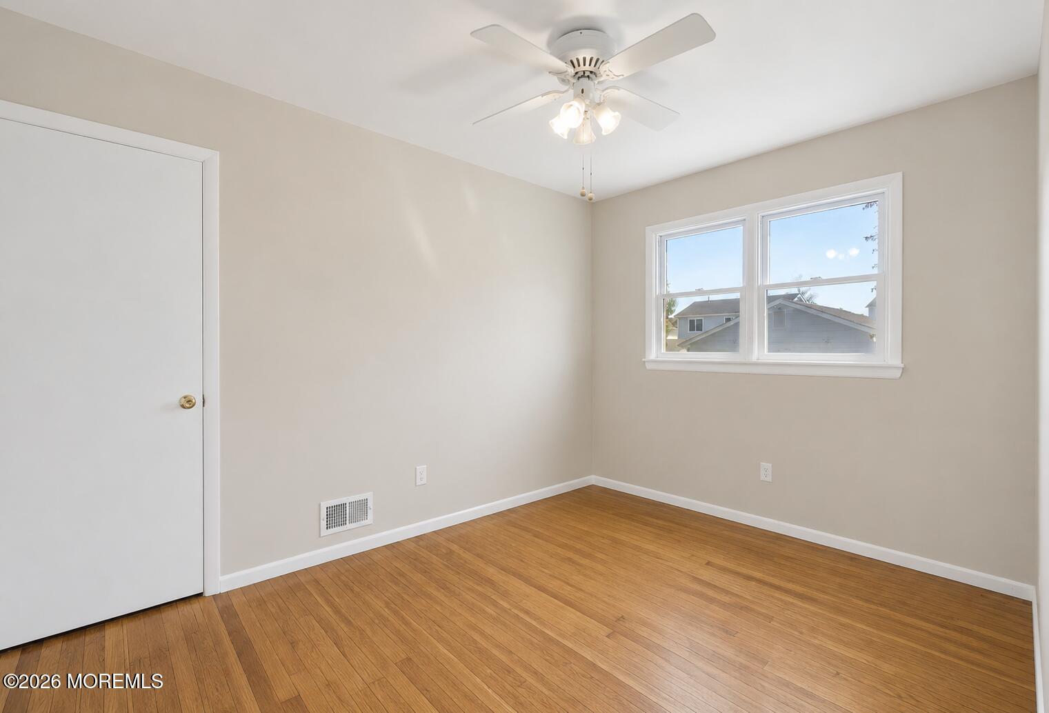 624 North Manetta Drive Point Pleasant, NJ 08742 - Photo 23 of 27 a view of empty room with wooden floor and fan