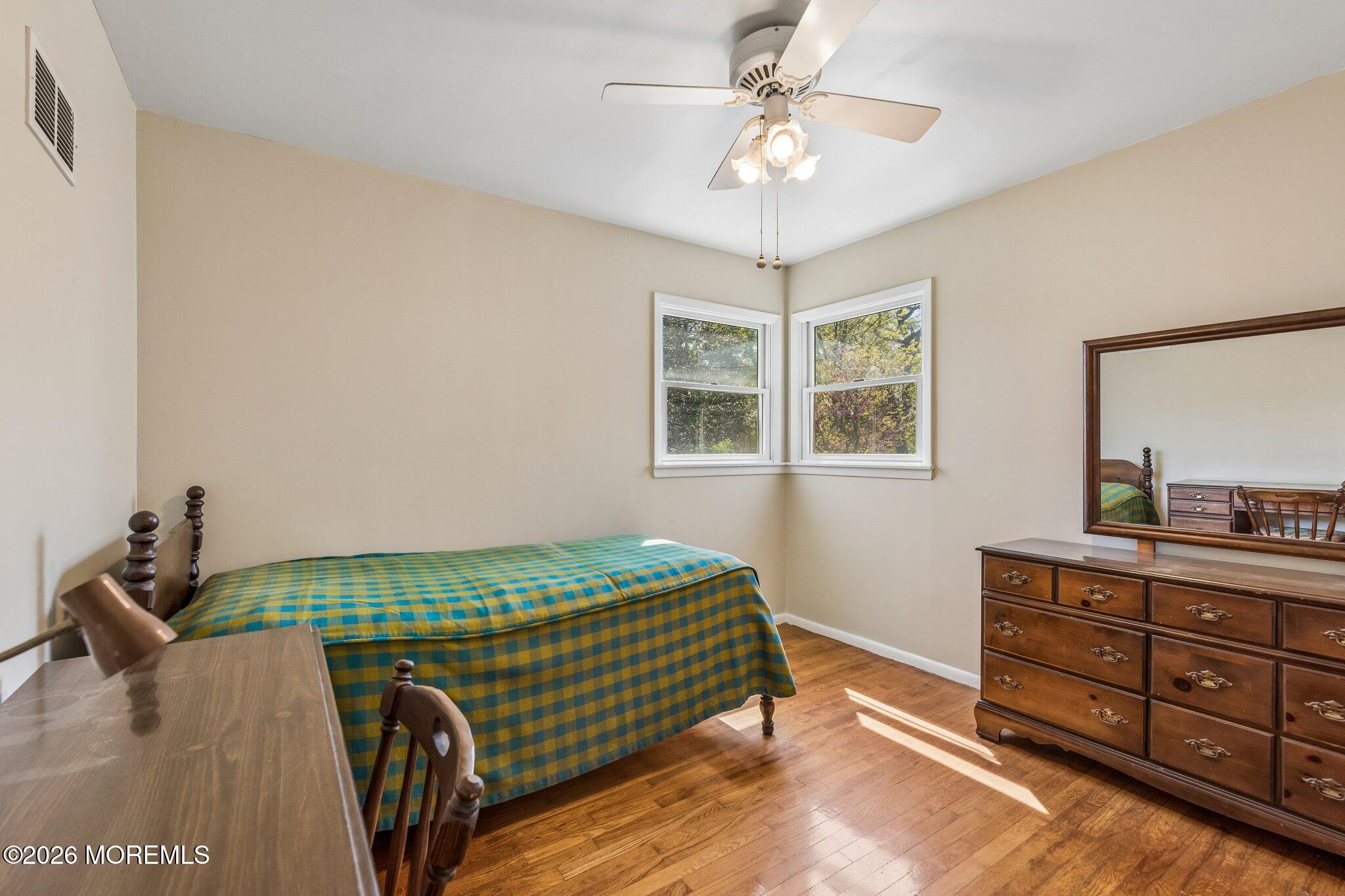 624 North Manetta Drive Point Pleasant, NJ 08742 - Photo 25 of 27 a bedroom with a bed and chandelier