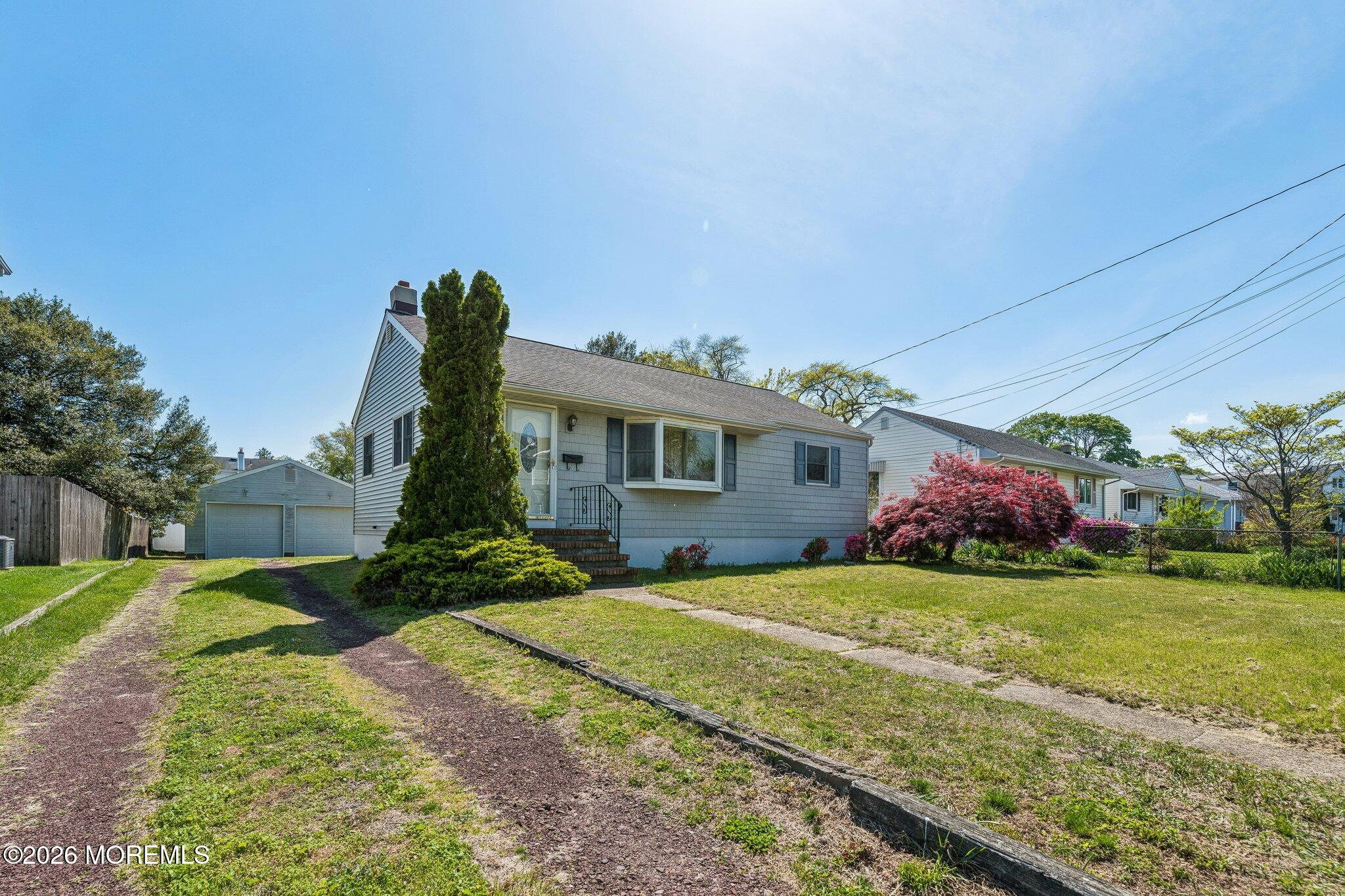 624 North Manetta Drive Point Pleasant, NJ 08742 - Photo 4 of 27 a front view of a house with a yard and garage