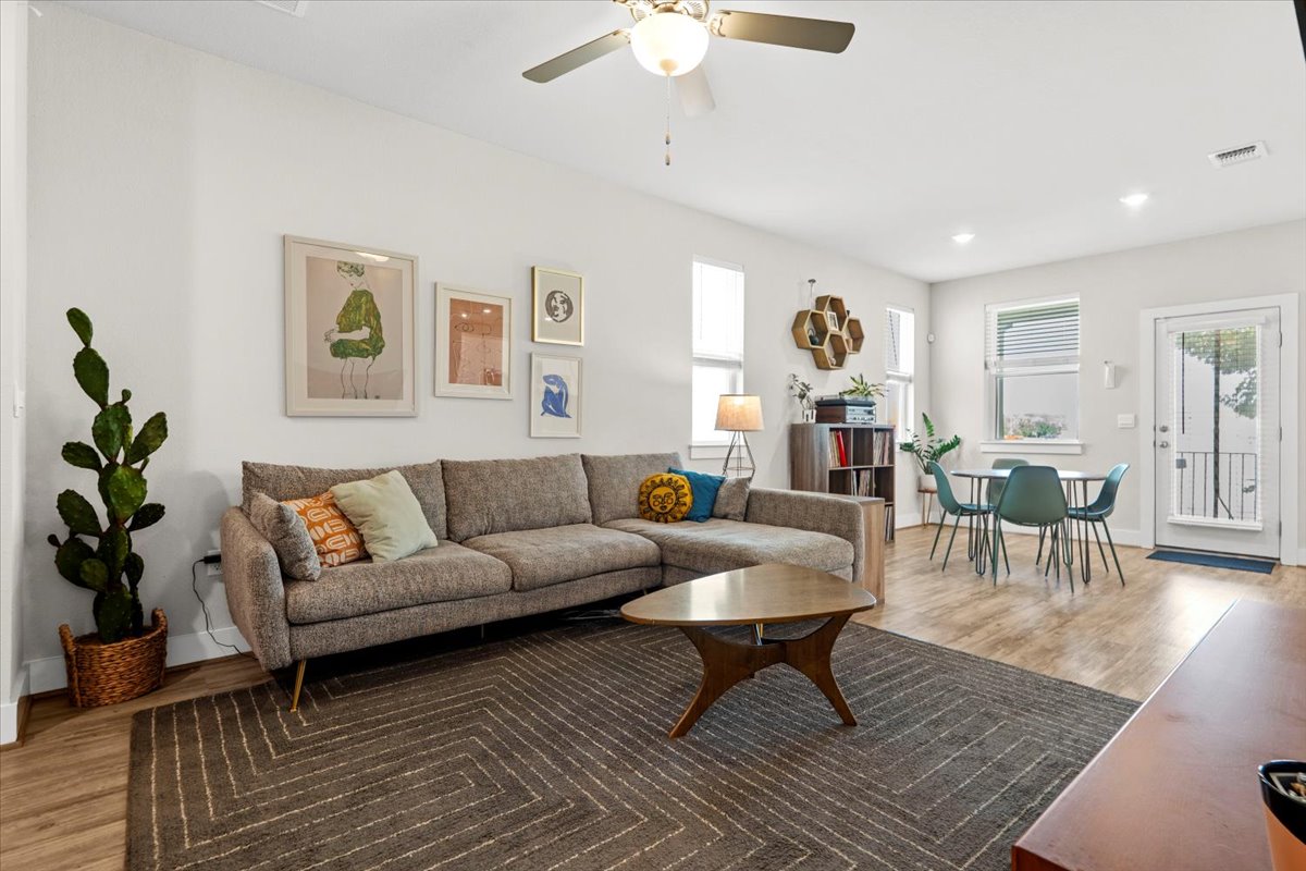 7110 Silver Star Lane Austin, TX 78744 - Photo 1 of 1 a living room with furniture and a wooden floor