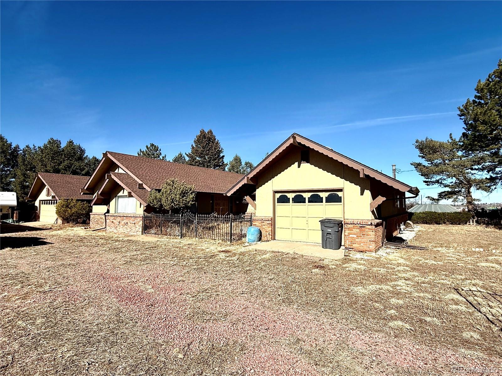 6105 West 49th Place Wheat Ridge, CO 80033 - Photo 11 of 40 a view of a house with a yard