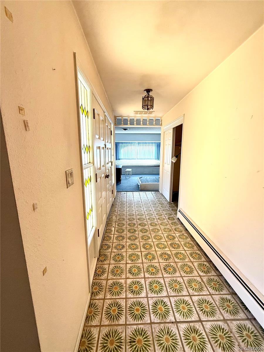 6105 West 49th Place Wheat Ridge, CO 80033 - Photo 22 of 40 a view of a hallway with wooden floor