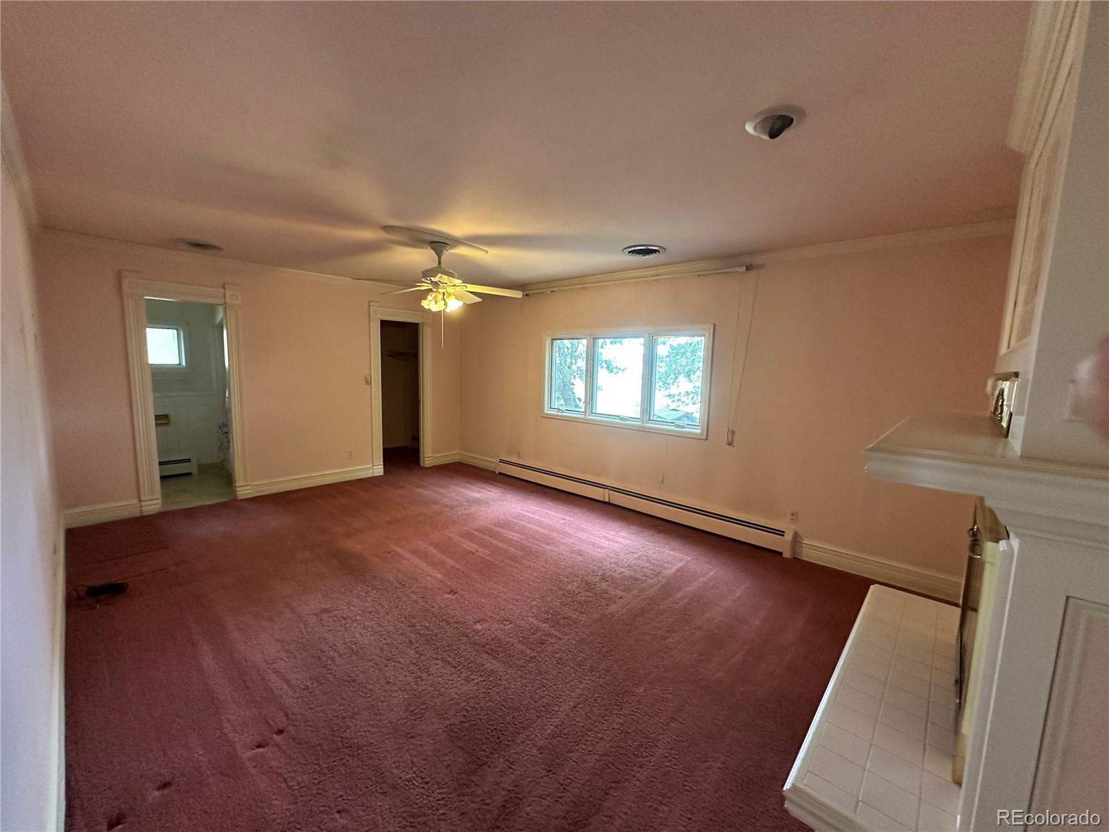 6105 West 49th Place Wheat Ridge, CO 80033 - Photo 27 of 40 an empty room with windows and entrance