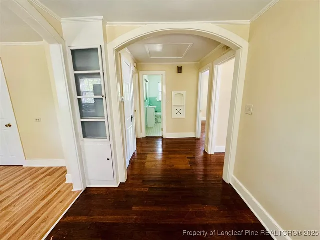 a view of a hallway with wooden floor and staircase