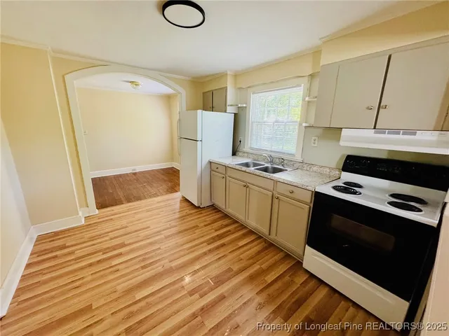 a kitchen with a stove and a refrigerator
