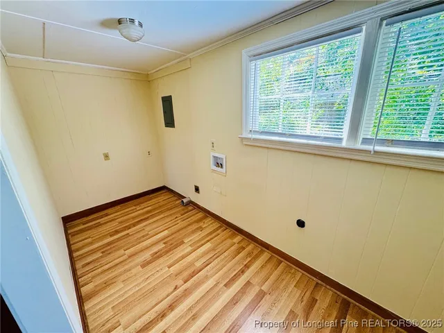 a view of a room with wooden floor and cabinet