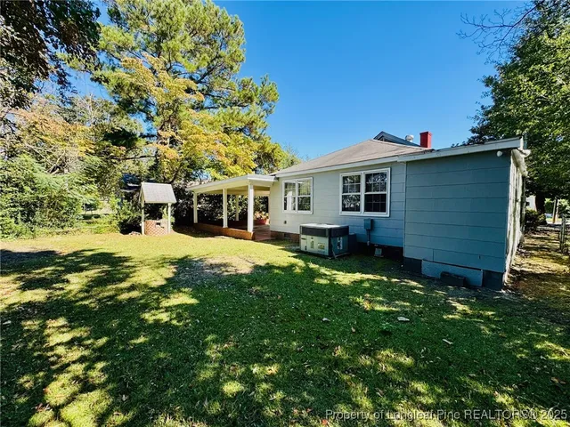 a front view of a house with yard patio and green space
