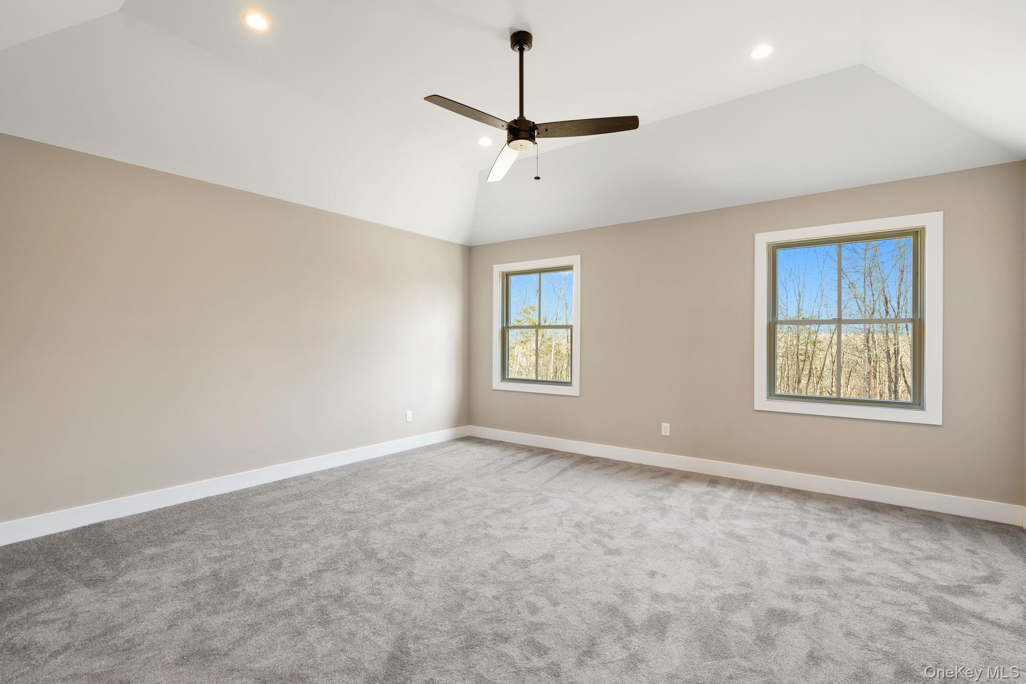 13 Harrier Ridge Drive Wallkill, NY 12589 - Photo 19 of 40 Spare room with vaulted ceiling, a ceiling fan, light carpet, and recessed lighting