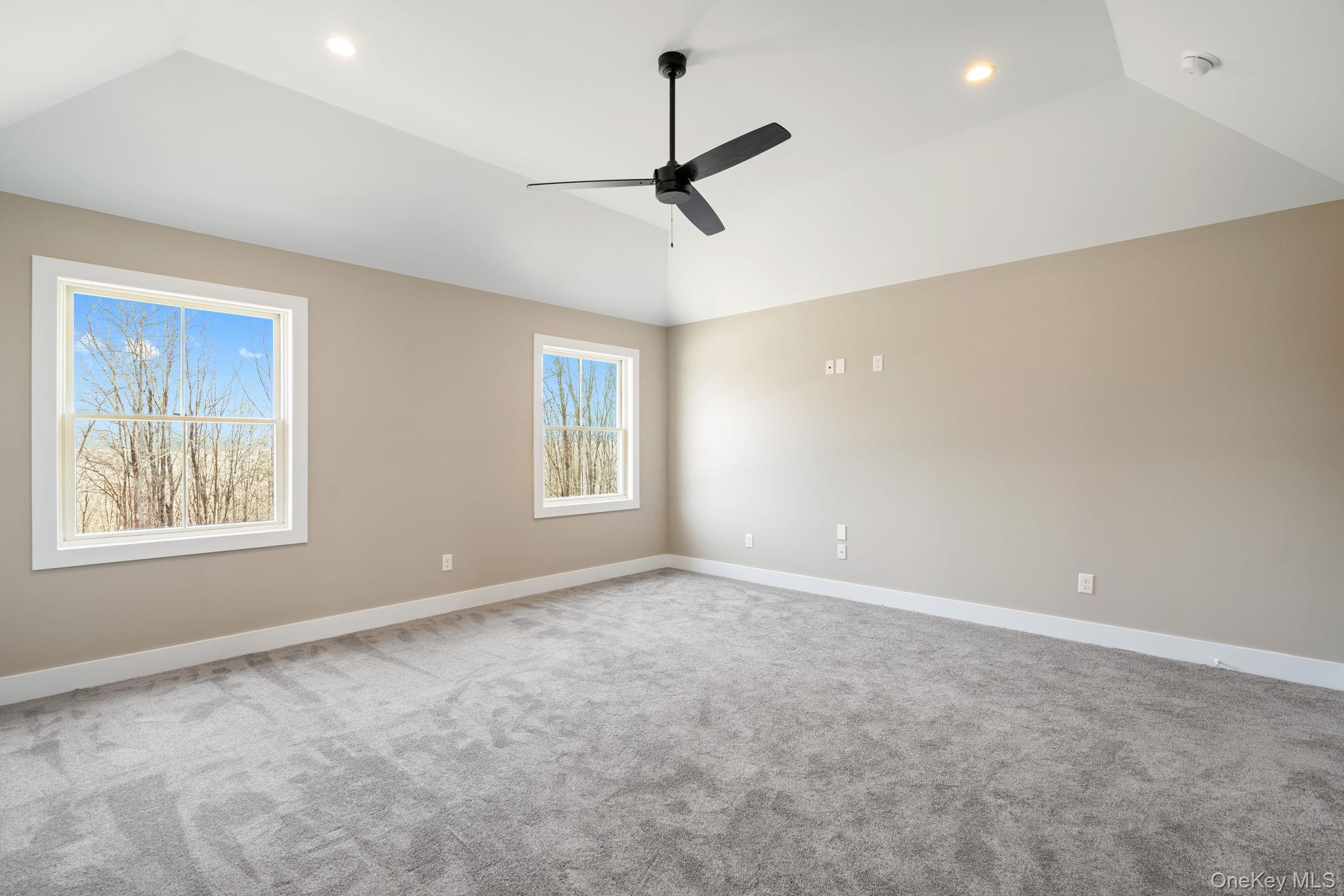 13 Harrier Ridge Drive Wallkill, NY 12589 - Photo 22 of 40 Carpeted spare room with vaulted ceiling and ceiling fan