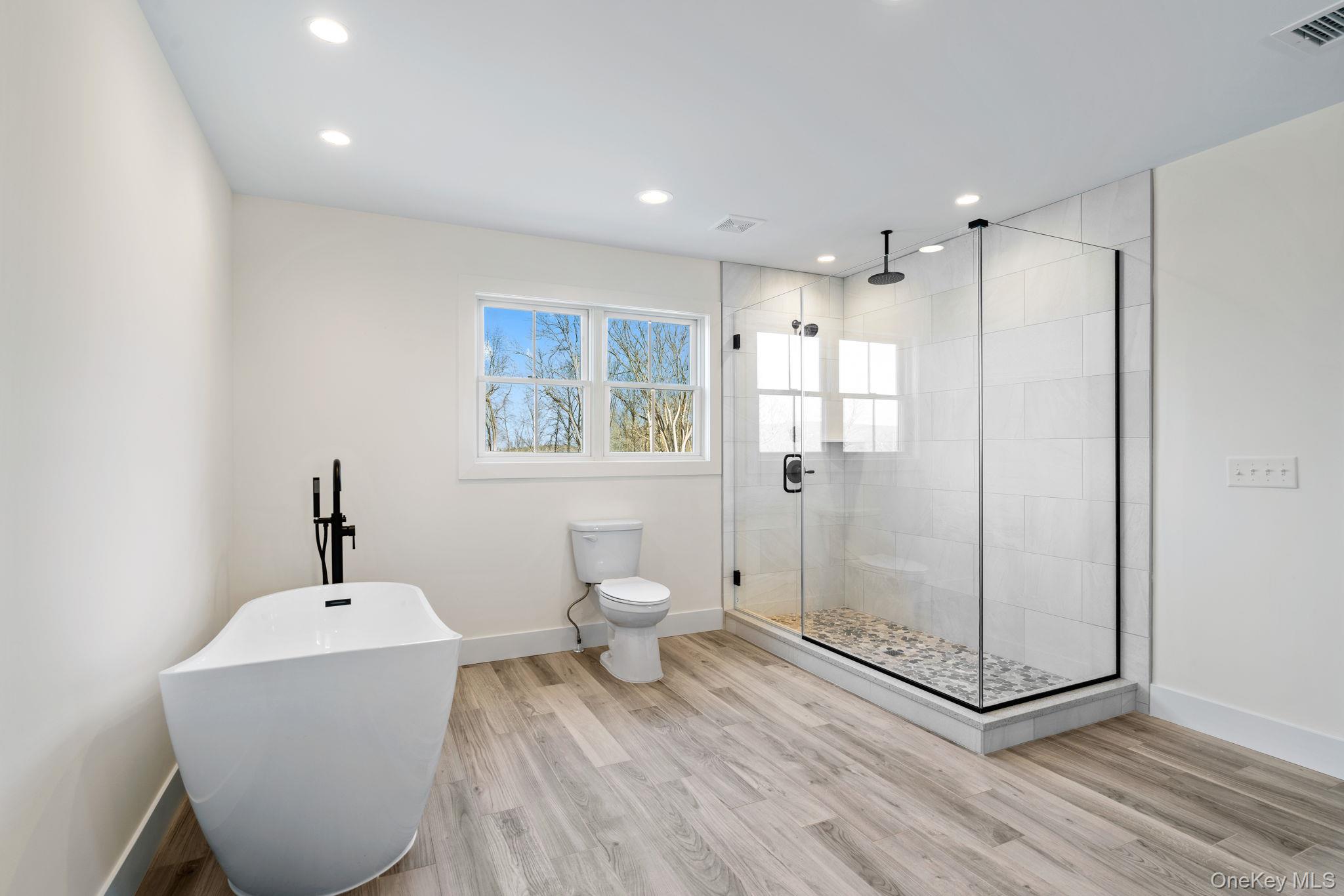 13 Harrier Ridge Drive Wallkill, NY 12589 - Photo 24 of 40 Bathroom featuring a soaking tub, a stall shower, light wood-style floors, and recessed lighting