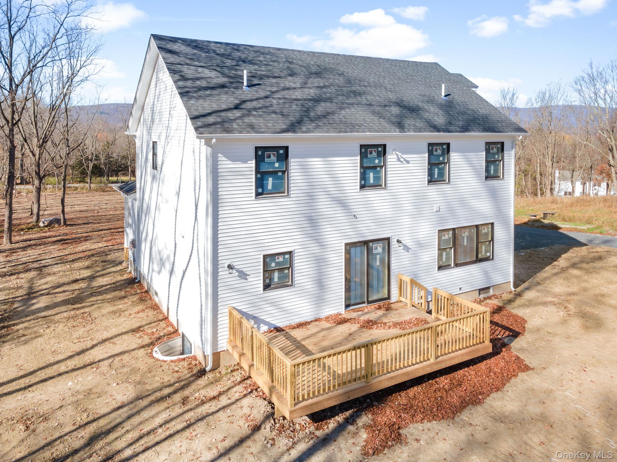13 Harrier Ridge Drive Wallkill, NY 12589 - Photo 38 of 40 Back of property with a wooden deck and a shingled roof