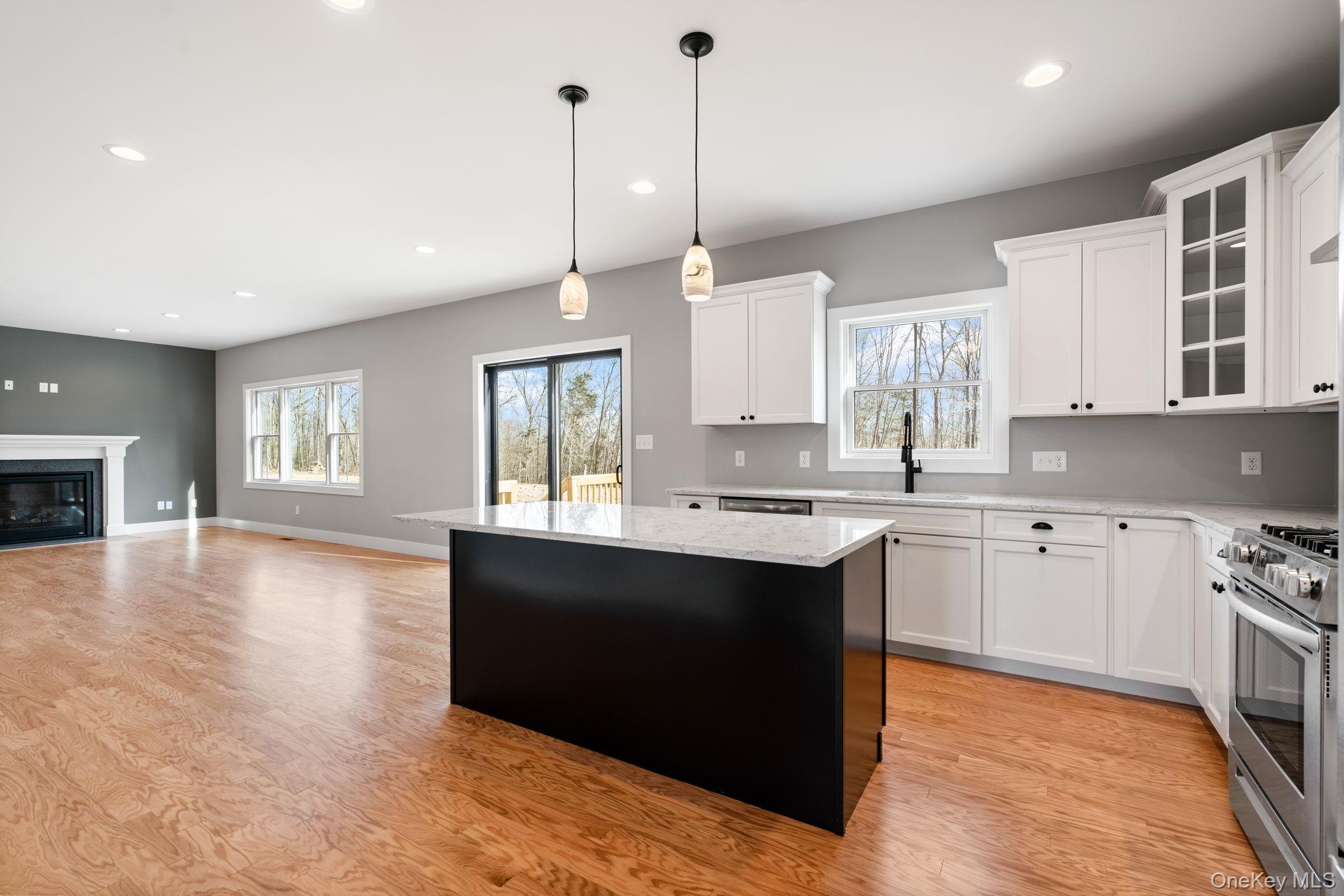 13 Harrier Ridge Drive Wallkill, NY 12589 - Photo 6 of 40 Kitchen with stainless steel range with gas stovetop, white cabinetry, hanging light fixtures, light wood-type flooring, and recessed lighting