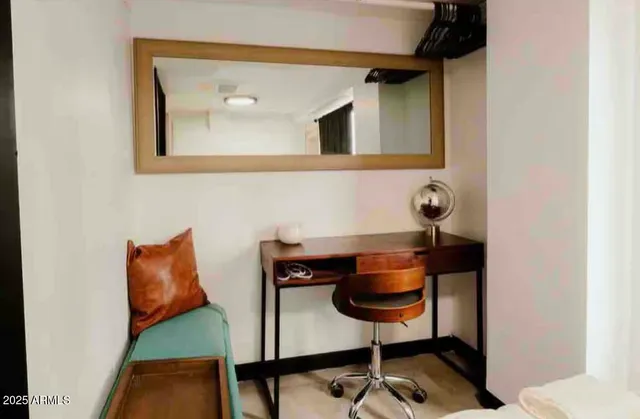 a white toilet sitting next to a bathroom and sink