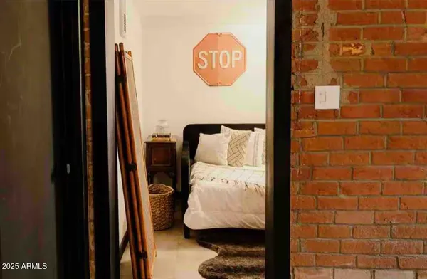 a bedroom with a bed and a window