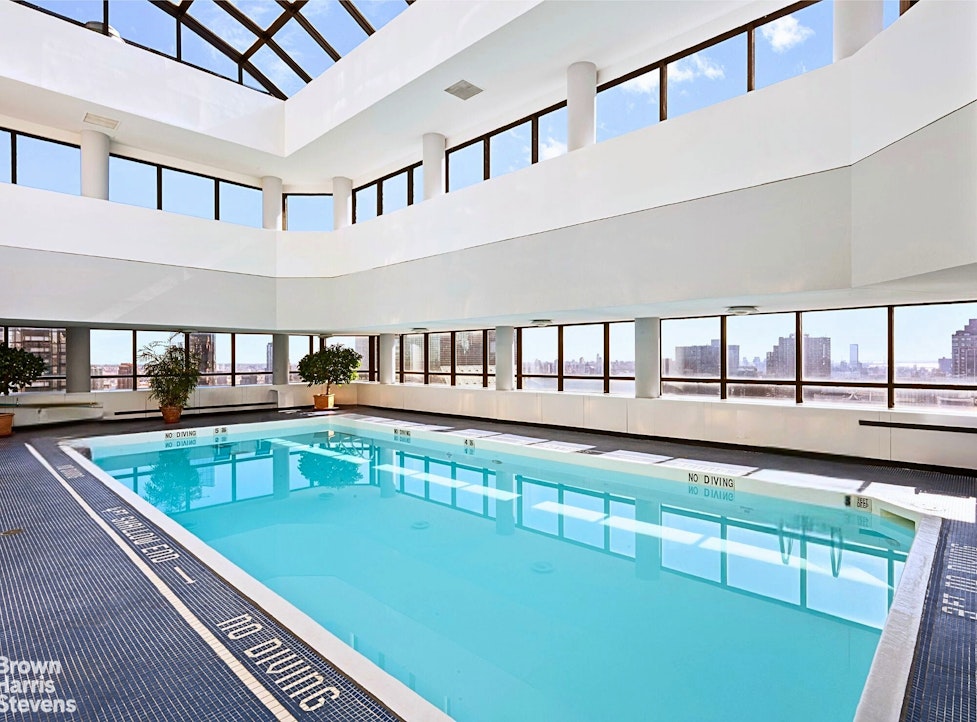 240 East 47th Street, Unit 39AB Manhattan, NY 10017 - Photo 15 of 22 a view of a swimming pool with a lounge chair