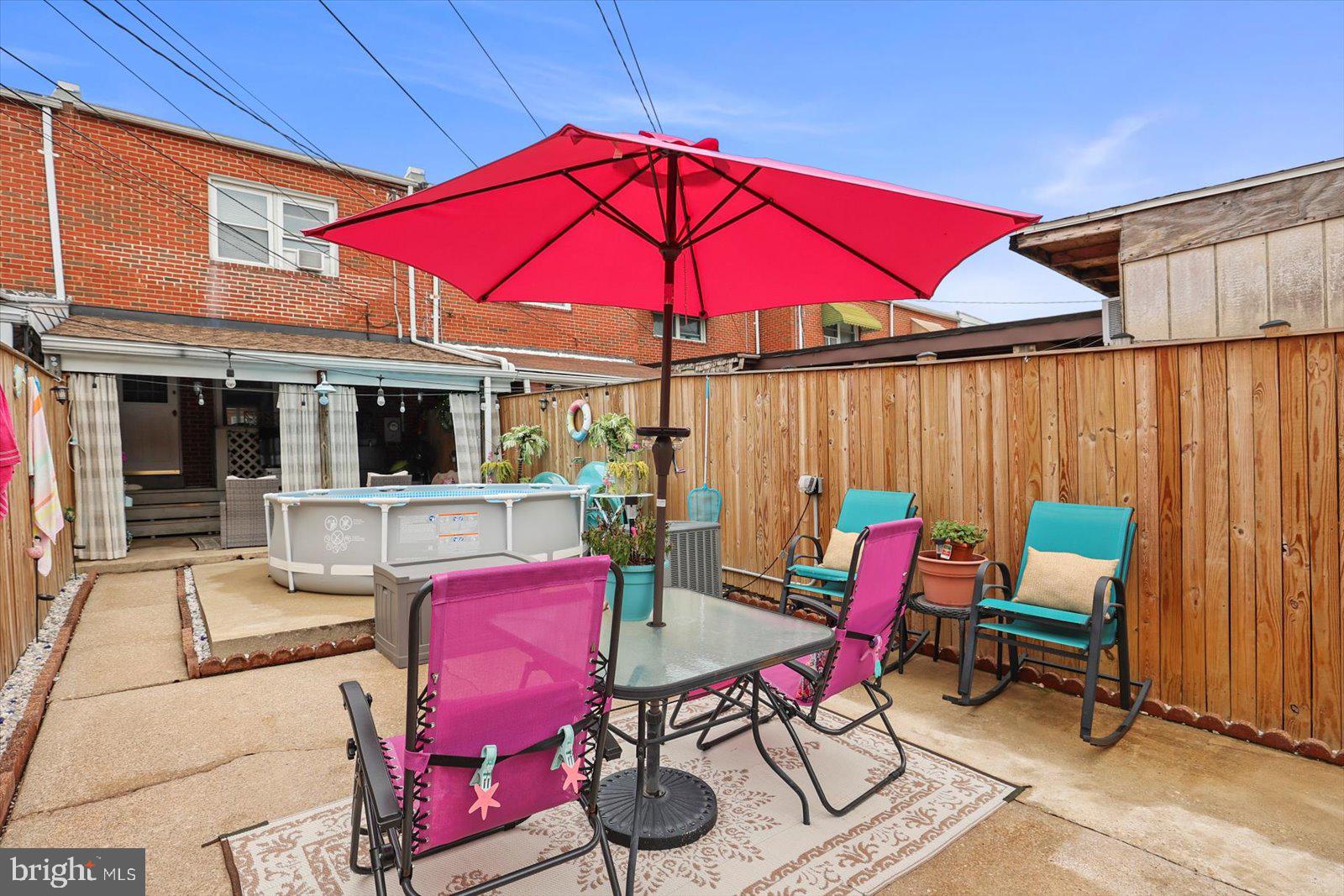 8131 Del Haven Road Baltimore, MD 21222 - Photo 8 of 35 a patio with a table and chairs under an umbrella