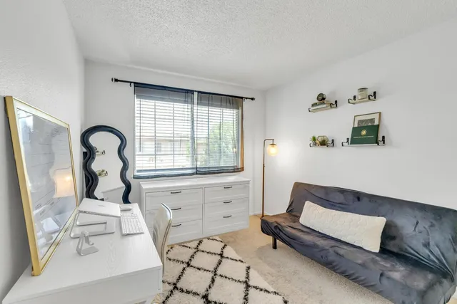 a bedroom with a bed and a large window