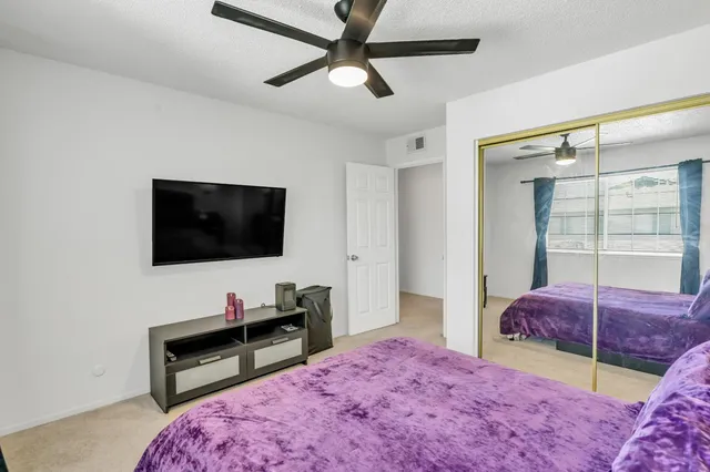 a bedroom with a bed and a flat screen tv