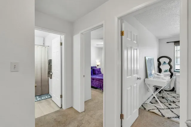 a view of a bedroom with bed and wooden floor