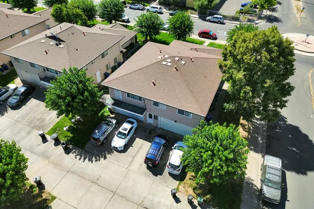 an aerial view of a house with a yard and garden