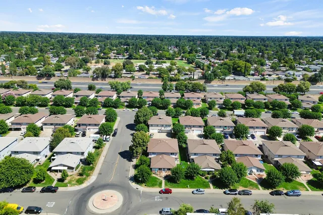 an aerial view of residential houses with outdoor space
