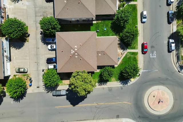 an aerial view of a house with garden space and a street view