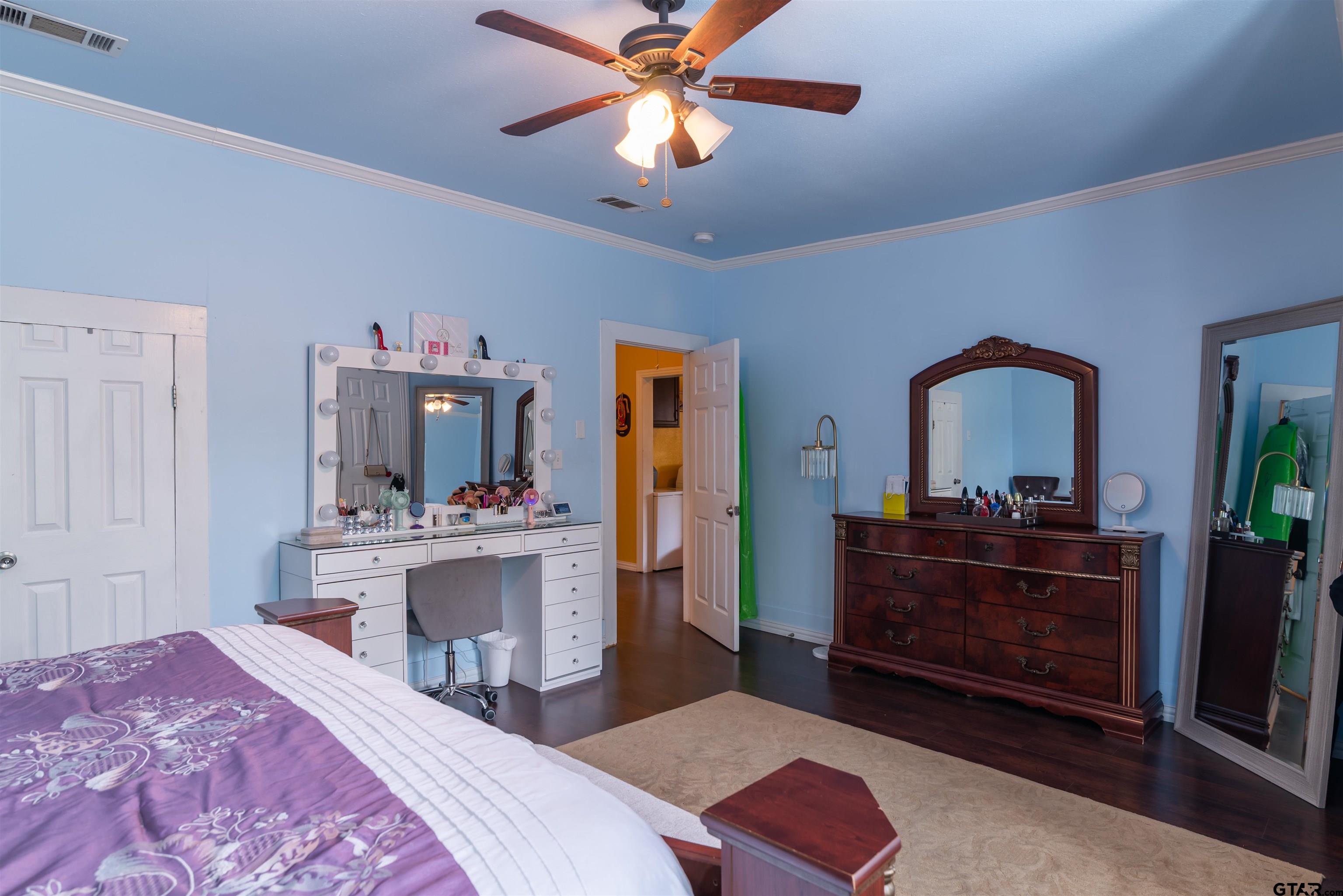 427 East Locust Street Tyler, TX 75702 - Photo 17 of 42 a bedroom with a bed and a chandelier