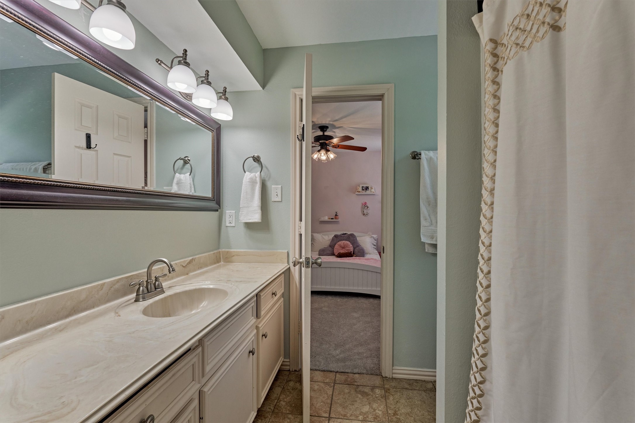6515 Glenhill Drive Spring, TX 77389 - Photo 28 of 39 a en suite bathroom with a sink double vanity granite and a mirror