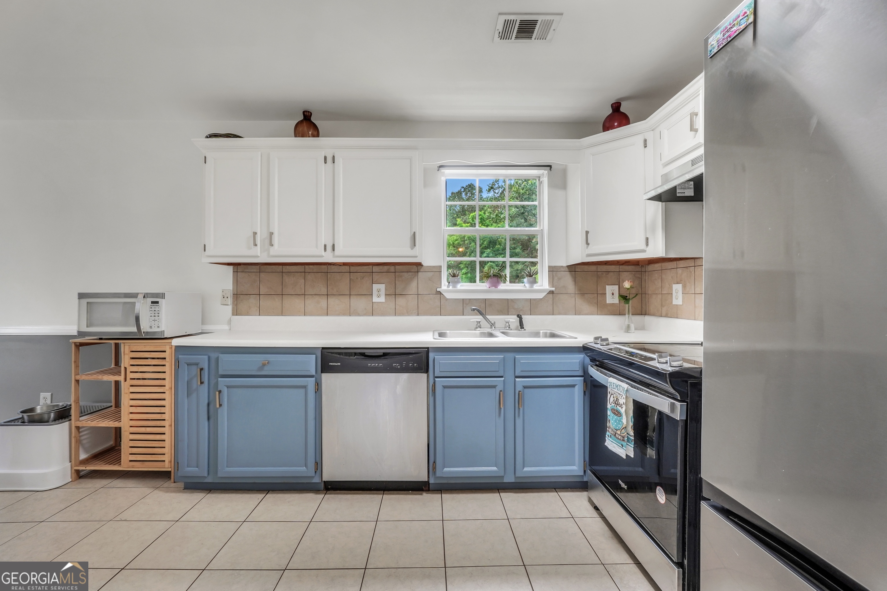110 Westeria Way Jackson, GA 30233 - Photo 12 of 45 a kitchen with stainless steel appliances granite countertop a stove sink and cabinets