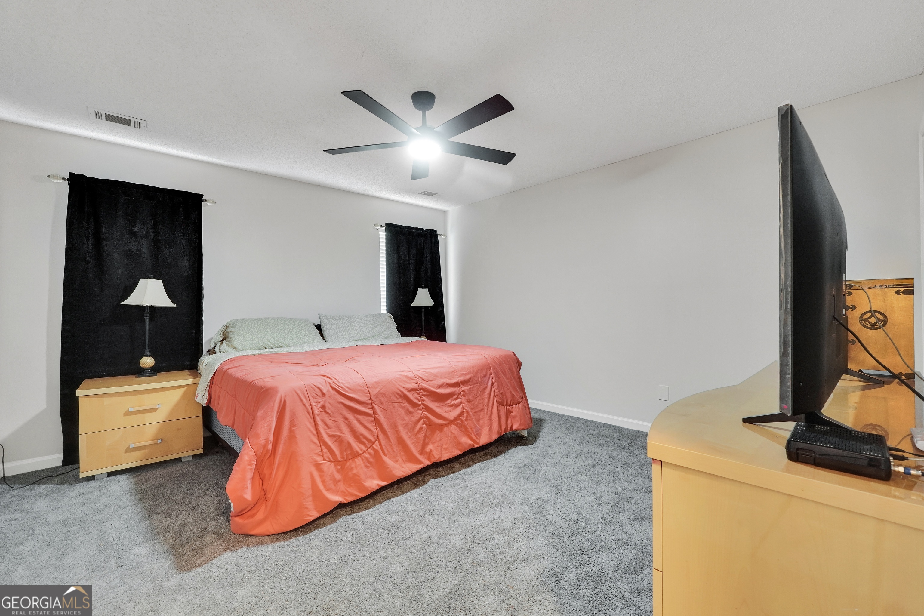 110 Westeria Way Jackson, GA 30233 - Photo 16 of 45 a bed room with a bed and a television