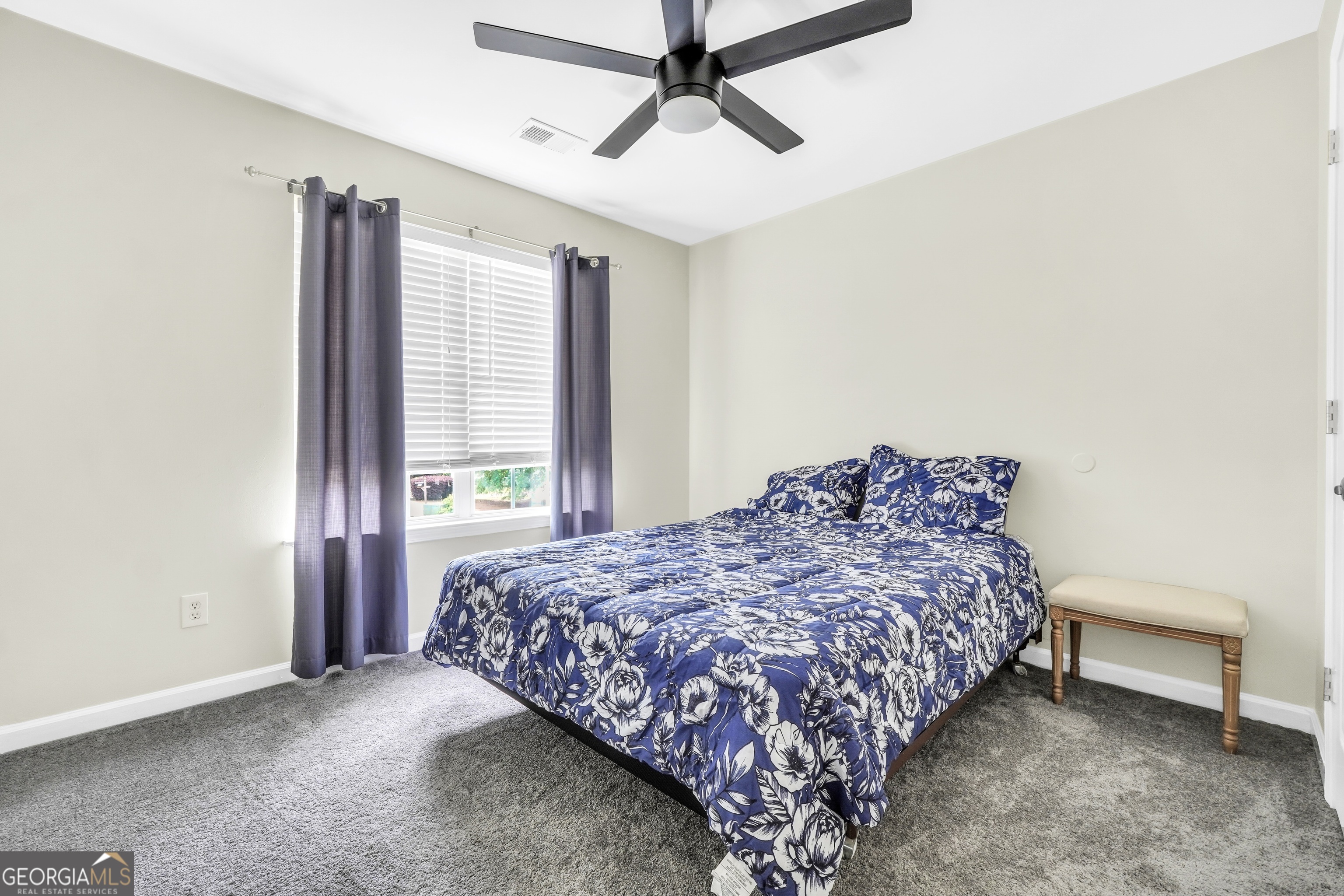 110 Westeria Way Jackson, GA 30233 - Photo 23 of 45 a bed sitting in a bedroom next to a window