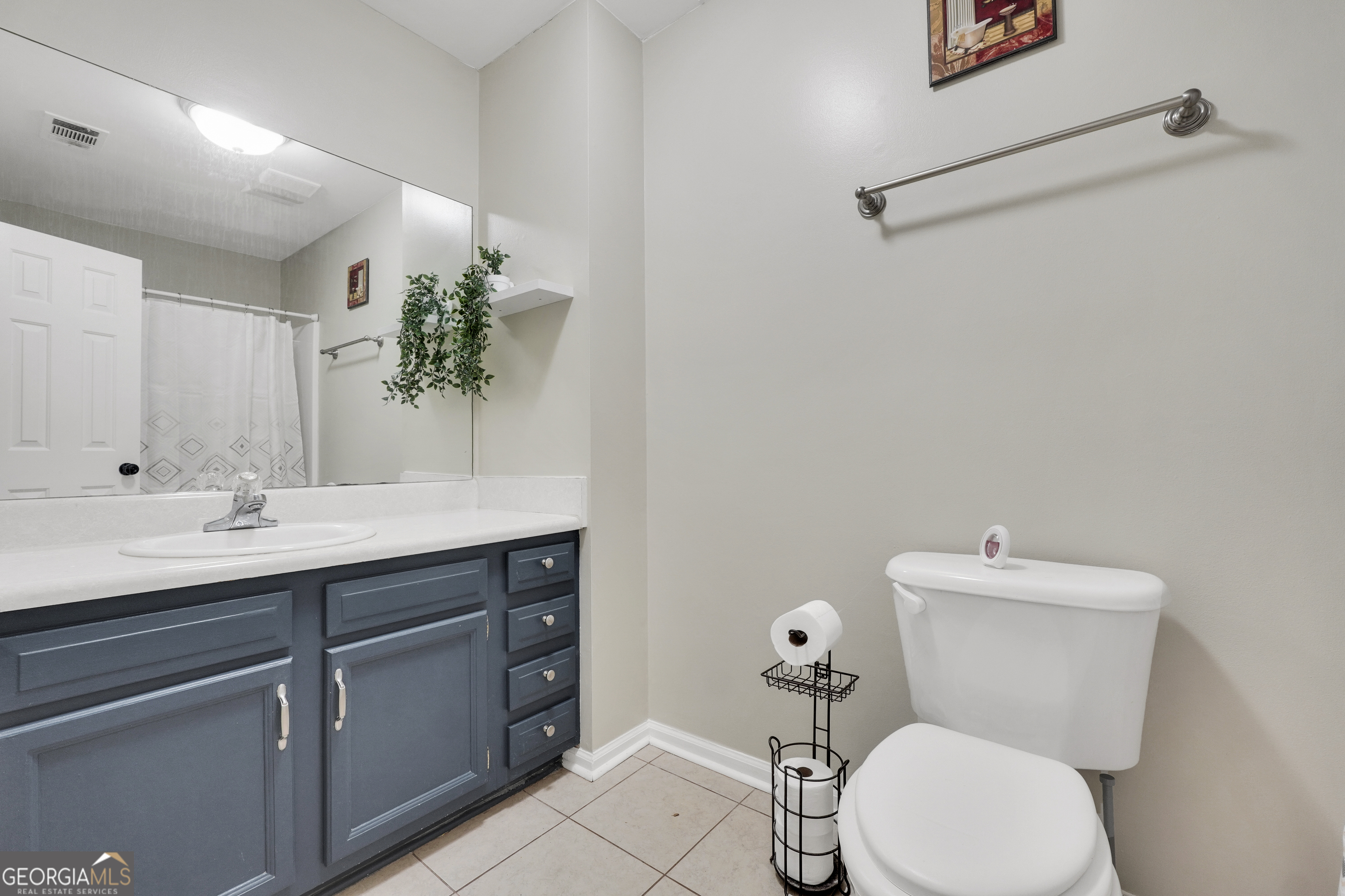 110 Westeria Way Jackson, GA 30233 - Photo 25 of 45 a bathroom with a toilet sink and mirror