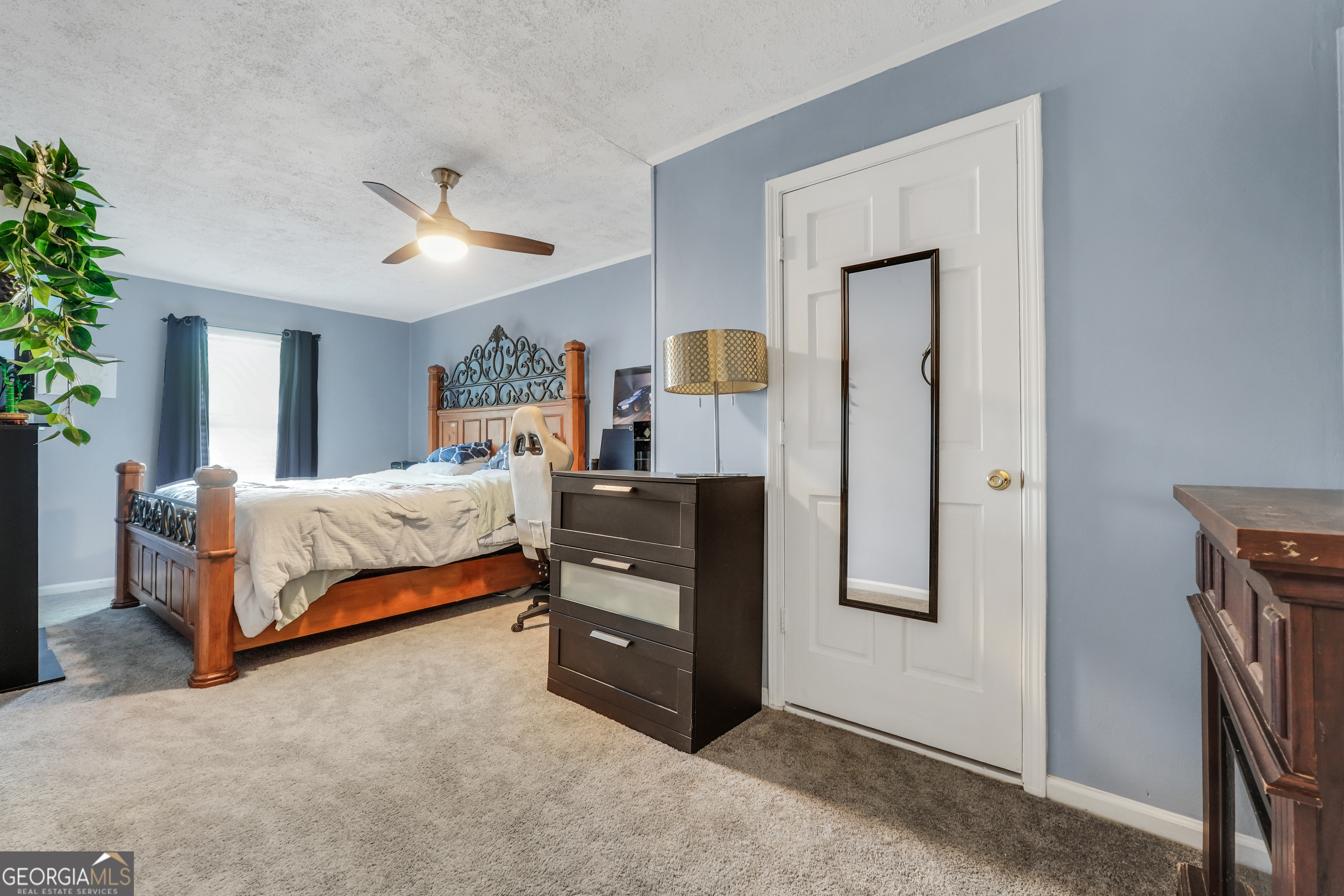 110 Westeria Way Jackson, GA 30233 - Photo 29 of 45 a bedroom with a bed and a chandelier
