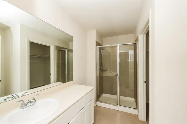 a bathroom with a shower and a sink