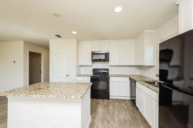 a kitchen with a sink stove and refrigerator
