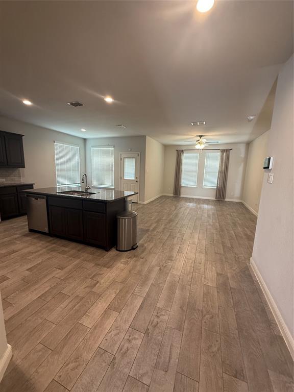 1110 Pacifica Trail Cleburne, TX 76033 - Photo 11 of 24 a view of kitchen and empty room with wooden floor