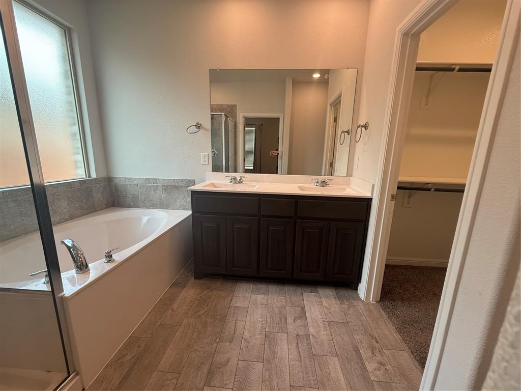 1110 Pacifica Trail Cleburne, TX 76033 - Photo 21 of 24 a bathroom with a tub sink and mirror
