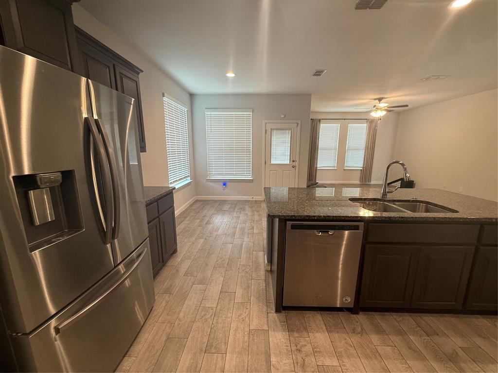 1110 Pacifica Trail Cleburne, TX 76033 - Photo 5 of 24 a kitchen with granite countertop a refrigerator and a sink