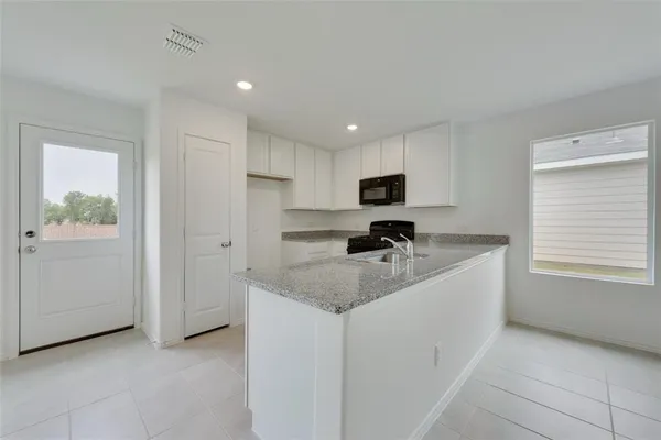 a kitchen that has a sink and a stove in it