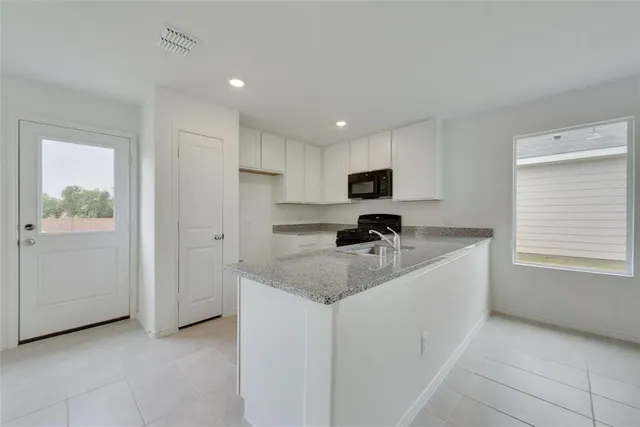 a kitchen that has a sink and a stove in it